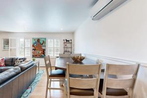 a kitchen and dining room with a table and chairs at Bird Street Breeze in Oak Bluffs