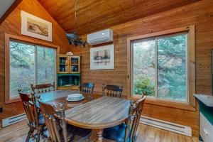 a dining room with a wooden table and chairs at Cozy Island Cabin in Edgartown