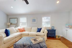 a living room with a white couch and blue pillows at Briarcliff Bliss in Barnstable
