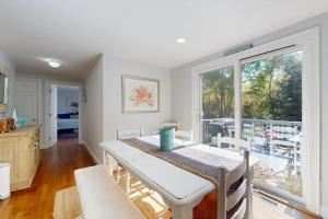 a dining room with a table and a large window at Briarcliff Bliss in Barnstable +30 photos