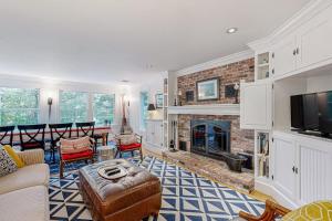 a living room with a couch and a fireplace at Mermaid's Rest in Centerville