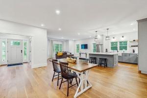 a kitchen and living room with a table and chairs at Heritage Escape in Mashpee