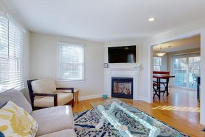 a living room with a couch and a fireplace at Pond View Getaway in Sandwich