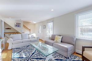 a living room with a couch and a table at Pond View Getaway in Sandwich