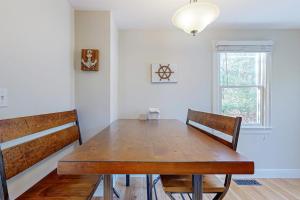 a dining room with a wooden table and two chairs at Pond View Getaway in Sandwich +18 photos