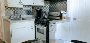 a kitchen with a stove and a sink at The Duo- Myles & Paul in Provincetown