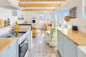 a kitchen with white cabinets and a counter top at Seas The Day in North Truro