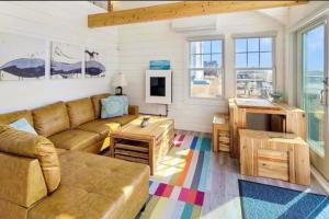 a living room with a couch and a table at Seas The Day in North Truro