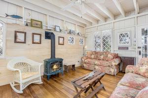 a living room with a wood stove in it at Anna's Cottage in Saugatuck