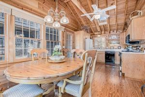 a dining room with a wooden table and chairs at Anna's Cottage in Saugatuck +25 photos