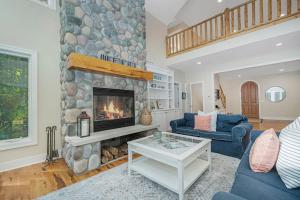 a living room with a fireplace and a blue couch at Thunder Road in Fennville