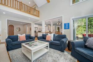 a living room with two blue couches and a table at Thunder Road in Fennville