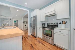 a kitchen with white cabinets and stainless steel appliances at Thunder Road in Fennville