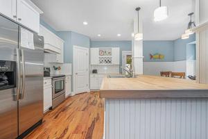 a large kitchen with white appliances and wooden floors at Thunder Road in Fennville