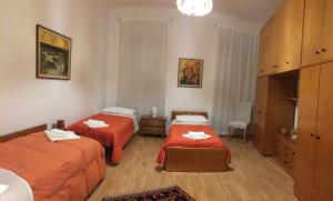 a hotel room with two beds with red sheets at Enjoy Trieste in Trieste