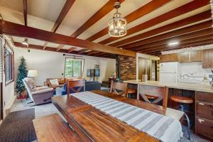 a kitchen and living room with a table in a room at Crystal Chalet in Thompsonville