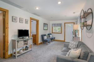 a living room with a couch and a tv at Tower Hill Cottage in Sawyer