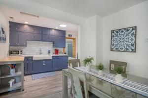a kitchen with blue cabinets and a table and chairs at Tower Hill Cottage in Sawyer +22 photos