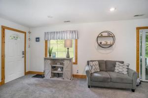 a living room with a couch and a window at Tower Hill Cottage in Sawyer