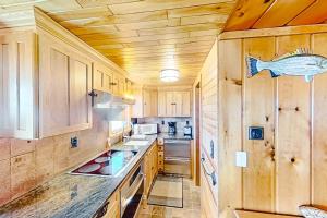 a kitchen with wooden cabinets and a counter top at Dune Grass Shores in Beulah