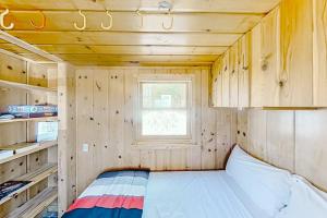 a small room with a bed in a cabin at Dune Grass Shores in Beulah