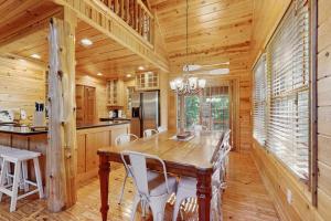 a dining room with a wooden table and chairs at Kingfisher Cove Cabin 19 in Saugatuck +24 photos