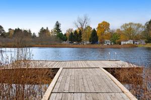 a wooden dock in the middle of a lake at Kingfisher Cove Cabin 19 in Saugatuck