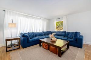 a living room with a blue couch and a coffee table at Gathering Place in Frankfort