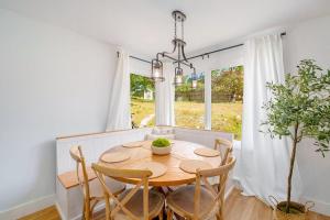 a dining room with a table and chairs and a window at Gathering Place in Frankfort