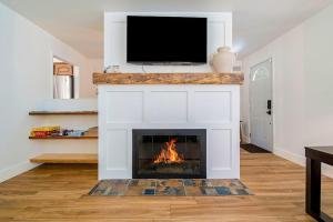 a living room with a fireplace with a tv on top at Gathering Place in Frankfort