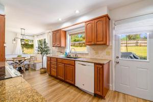 a kitchen with wooden cabinets and a sink and a table at Gathering Place in Frankfort +27 photos