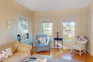 a living room with a couch and two chairs at Green Glen in Empire