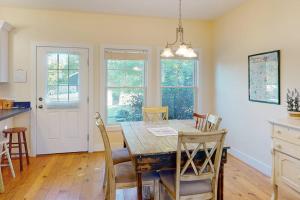 a kitchen and dining room with a wooden table and chairs at Green Glen in Empire