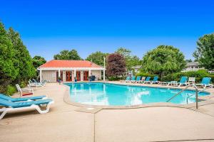 a swimming pool with lounge chairs and a house at Bluebird Condo in Douglas