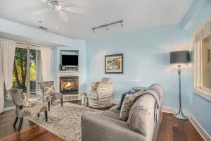 a living room with a couch and chairs and a fireplace at Bluebird Condo in Douglas