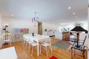 a dining room and kitchen with a white table and chairs at Downtown Hideaway in New Buffalo