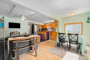 a kitchen and living room with a table and chairs at Carol's Cottage in Empire