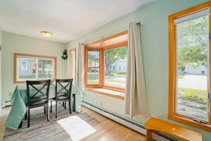 a dining room with a table and chairs and a window at Carol's Cottage in Empire