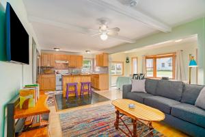 a living room with a couch and a table at Carol's Cottage in Empire