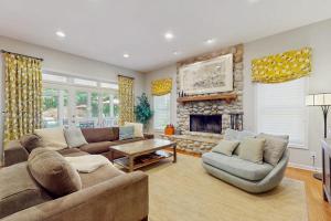 a living room with a couch and a fireplace at Grand Getaway in Grand Beach