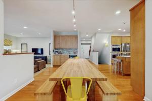 a kitchen with a wooden table and yellow chairs at Grand Getaway in Grand Beach