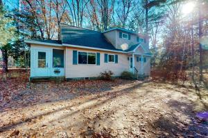 a small house on a dirt road in the woods at Uncle Warren's Retreat in Glen Arbor