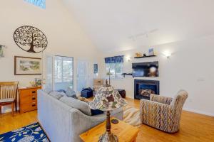 a living room with a couch and a fireplace at Uncle Warren's Retreat in Glen Arbor