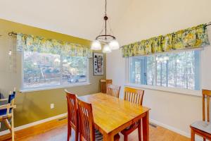 a dining room with a wooden table and chairs at Uncle Warren's Retreat in Glen Arbor