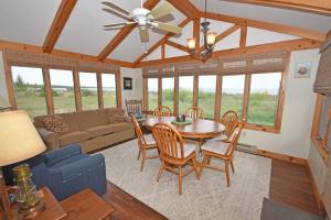 a living room with a table and chairs and a couch at Ships Haven in Glen Arbor