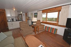 a living room with a couch and chairs and a table at Ships Haven in Glen Arbor