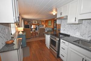 a kitchen and living room in a tiny house at Ships Haven in Glen Arbor +12 photos