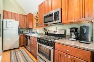 a kitchen with wooden cabinets and a stove top oven at The Stonewater Lodge in Traverse City