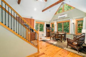 a living room with a staircase and a dining room at The Stonewater Lodge in Traverse City