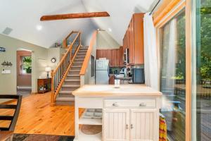 a kitchen and living room with a staircase at The Stonewater Lodge in Traverse City
